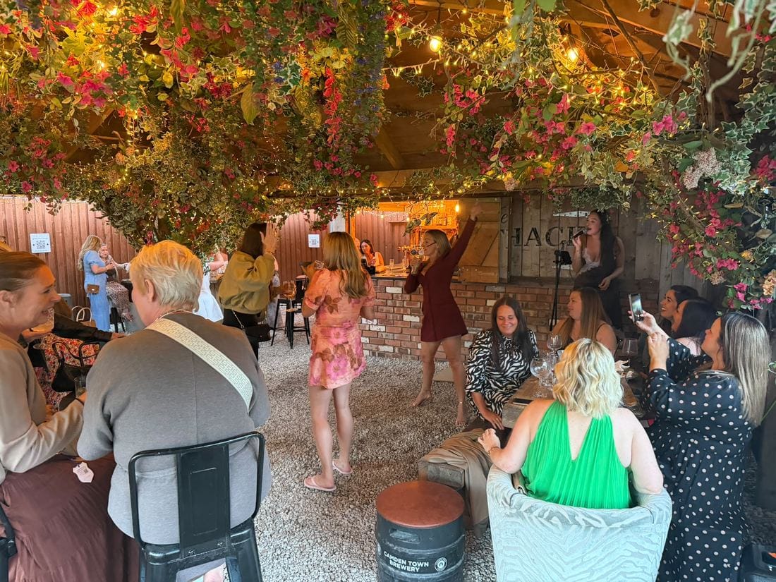 A private party gathered under the marquee with cocktails