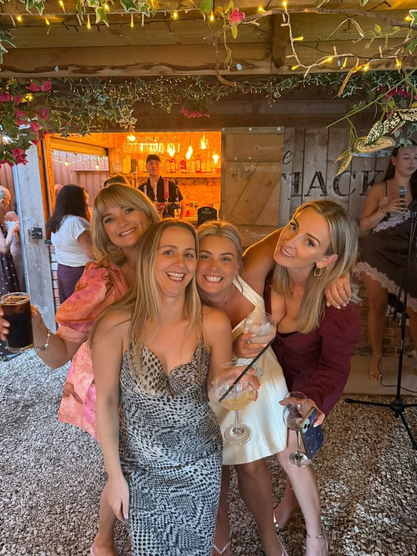 Friends celebrating together at the bar under the pergola