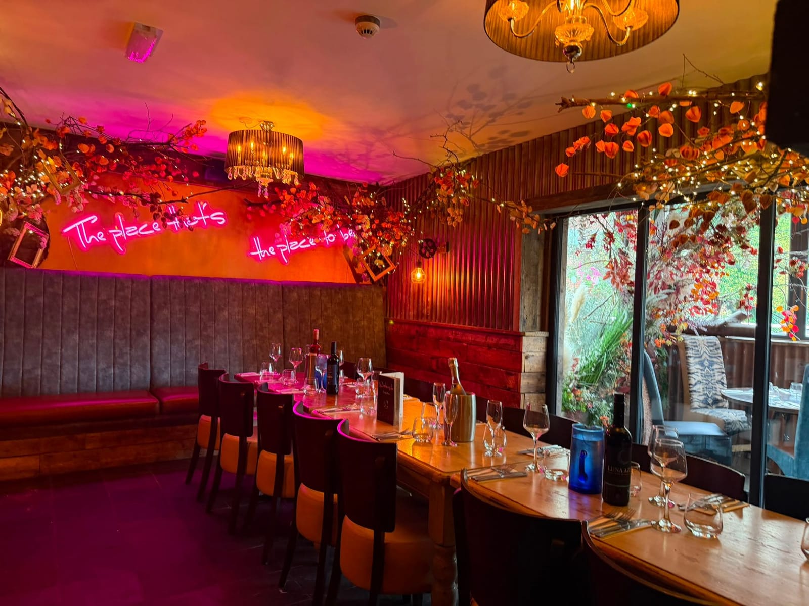 The semi-private dining area seen through the brick fireplace, set for a celebration