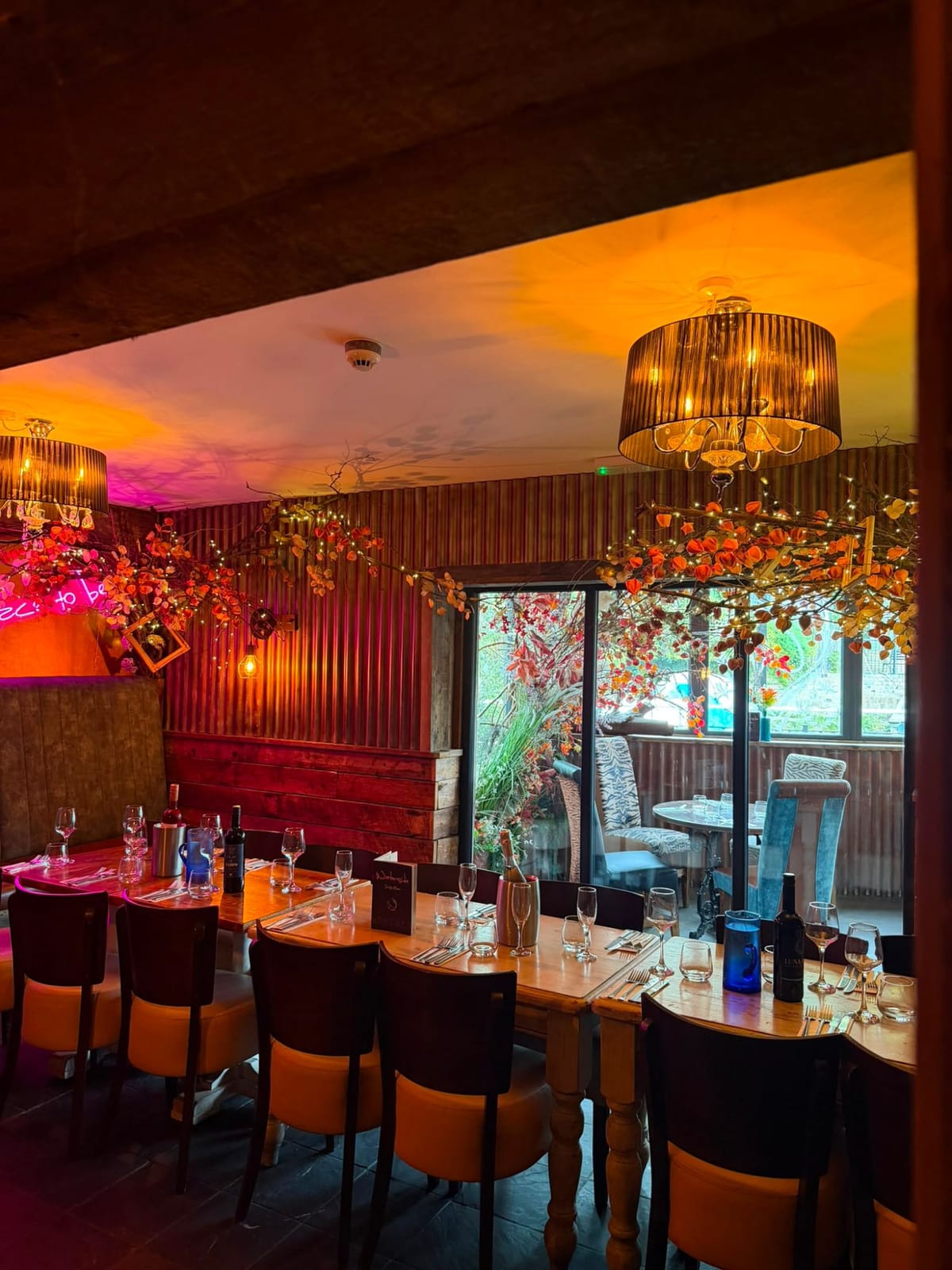 A private party table in the semi-private dining area, with garden views through the glass doors
